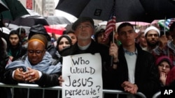 Mark Lukens, a pastor at Bethany Congregational Church, holds a sign at the "Today, I Am A Muslim, Too" rally in New York City, March 6, 2011. The rally was held in response to the upcoming Congressional hearings to be led by Rep. Peter King.