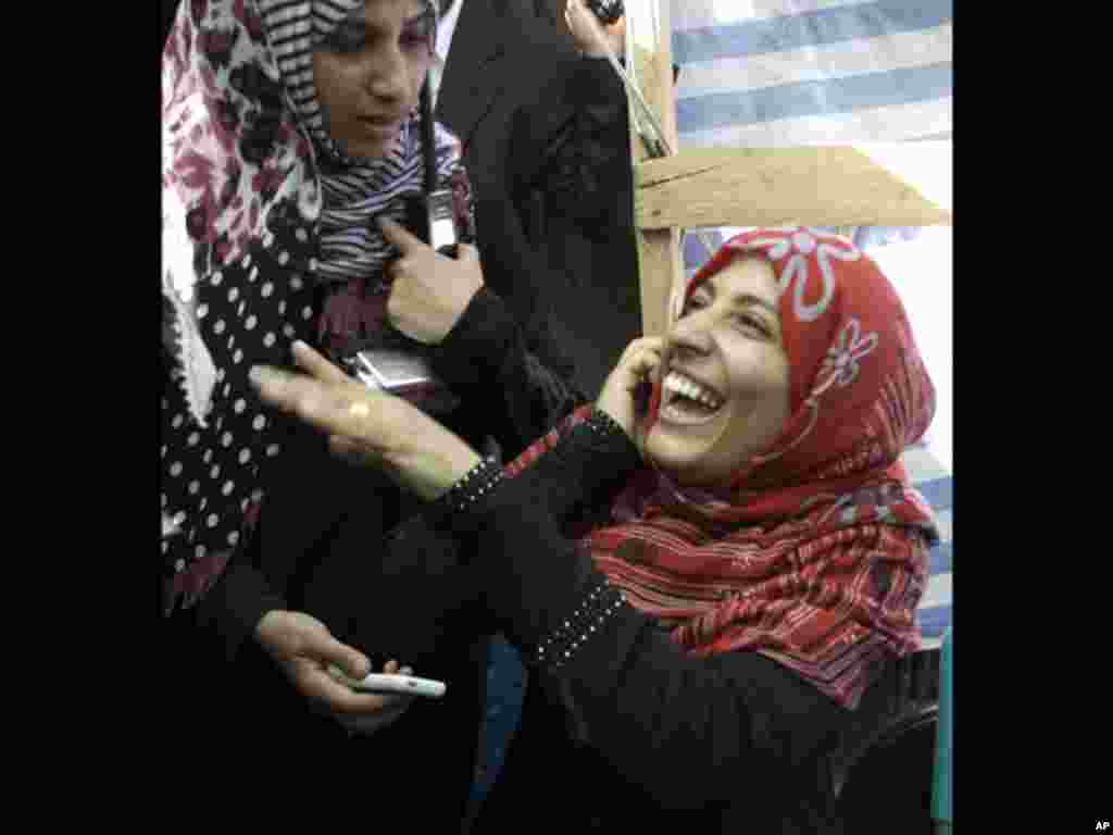 Yemeni activist Tawakkul Karman laughs as she speaks on the telephone after the announcement of the 2011 Nobel Peace Prize in Sanaa, Yemen, Friday, Oct. 7, 2011. The 2011 Nobel Peace Prize was awarded Friday to Liberian President Ellen Johnson Sirleaf, Li