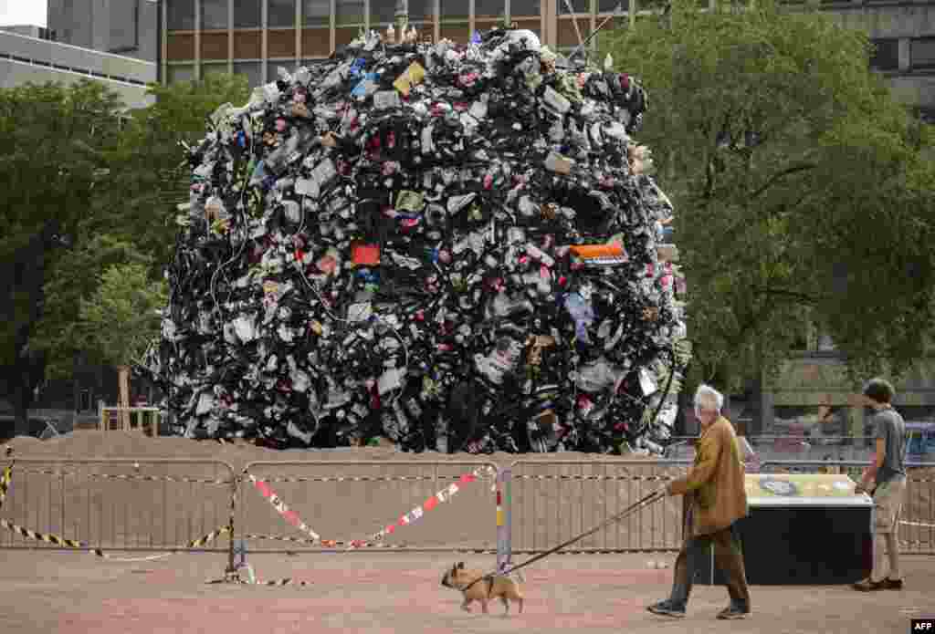 A giant globe of 35 tons of garbage in the center of Geneva, Switzerland. The city has launched a campaign against litter by exhibiting a giant ball that represents the rubbish collected off bins in three days, on Plainpalais place.