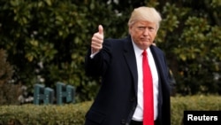 FILE - U.S. President Donald Trump gives a thumbs up as he departs the White House in Washington to spend the weekend in Florida, Feb. 3, 2017. 