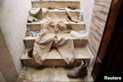 FILE - A uniform of a member of Islamic State militants is pictured as it was displayed by the Syrian Democratic forces at their positions inside a building at the frontline in Raqqa, Syria, Oct. 6, 2017.