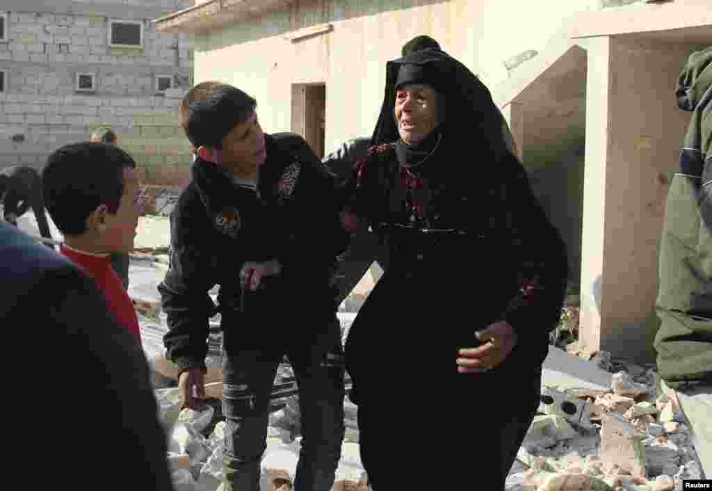 A woman reacts after what activists said was shelling from forces loyal to Syria&#39;s President Bashar al-Assad in Al-Atareb, Aleppo countryside, Feb. 16, 2014.