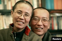 FILE - Chinese dissident Liu Xiaobo and his wife, Liu Xia, pose in this undated photo released by his family on Oct. 3, 2010.
