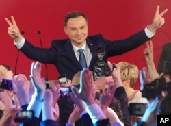 Opposition candidate Andrzej Duda celebrates with supporters his victory, as first exit polls in the presidential runoff voting are announced in Warsaw, Poland, May 24, 2015.