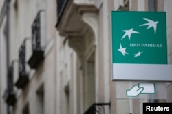 FILE - The logo of BNP Paribas bank is pictured on an office building in Nantes, France, July 21, 2017.