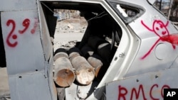 FILE - Bombs inside a vehicle used by the Islamic State militants in suicide car bombings are pictured after a demining team defused them in Raqqa, Syria.