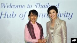 Burma's Aung San Suu Kyi, left, shakes hands with Thailand's Prime Minister Yingluck Shinawatra in this picture from the Thai government. 