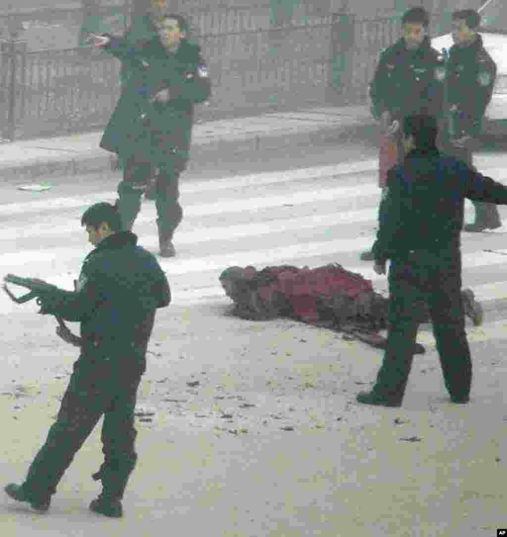 In this photo released by International Campaign for Tibet, armed police surround a Tibetan Buddhist monk named Tapey after he set himself ablaze in Aba, in China's southwest Sichuan province. Chinese state media confirmed that a Tibetan Buddhist monk had