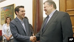 Socialist PASOK party leader Evangelos Venizelos (R) and Greece's Left Coalition party head Alexis Tsipras shake hands during their meeting at the parliament in Athens, May 11, 2012.