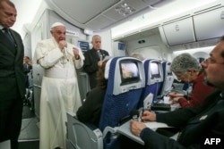 FILE - Pope Francis speaks to journalists aboard the flight from Mexico to Italy, on Feb. 18, 2016.