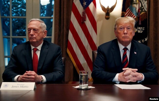 FILE - President Donald Trump gets a briefing from his senior military leaders, including then-Defense Secretary James Mattis, at left, in the Cabinet Room at the White House, Oct. 23, 2018.