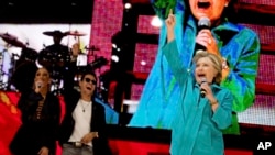 ຜູ້ລົງແຂ່ງຂັນເອົາຕຳແໜ່ງປະທານາທິບໍດີ ທ່ານນາງ Hillary Clinton, ພ້ອມກັບນັກຮ້ອງຊື່ດັ່ງ ນາງ Jennifer Lopez, ຊ້າຍ, ແລະ ນັກຂຽນເພງທ່ານ Marc Anthony, ທີສອງ
ຈາກຊ້າຍ, ກ່າວໃນງານສະແດງ ອອກມາເພື່ອລົງຄະແນນສຽງ ທີ່ໂຮງລະຄອນ Amphitheater ສວນ Bayfront, ເມືອງ Miami, 29 ຕຸລາ, 2016. 