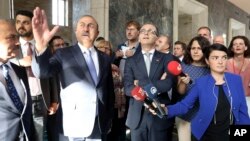 Turkey's Foreign Minister Mevlut Cavusoglu (2nd-L) talks to German Foreign Minister Heiko Mass (C-R) during a visit to a section of the Turkish parliament, damaged during the failed July 15, 2016 coup attempt, in Ankara, Turkey, Sept. 5, 2018. 