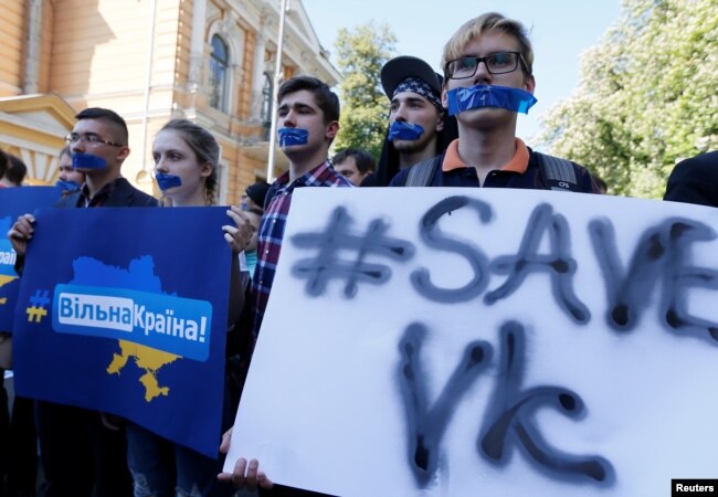 People hold placards during a protest against a ban of Russian social networks Vkontakte by the Ukrainian government, in Kiev, Ukraine, May 19, 2017.