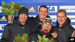 Steve Holcomb, bottom center, with bobsled crew members on the trophy stand