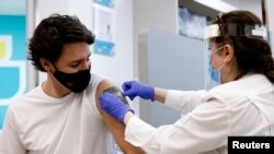 Canada's Prime Minister Justin Trudeau gets a band-aid after being inoculated with AstraZeneca's vaccine against coronavirus disease (COVID-19) at a pharmacy in Ottawa, Ontario, Canada April 23, 2021. 