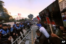 Protesters try to break a police cordon during an anti-government rally in Tirana, Albania, May 11, 2019. Protesters demand the Socialist government resign and call an early parliamentary election.