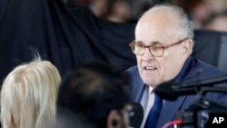 FILE - Former New York City mayor Rudy Giuliani speaks to reporters in Charlotte, N.C., March 2, 2018. 