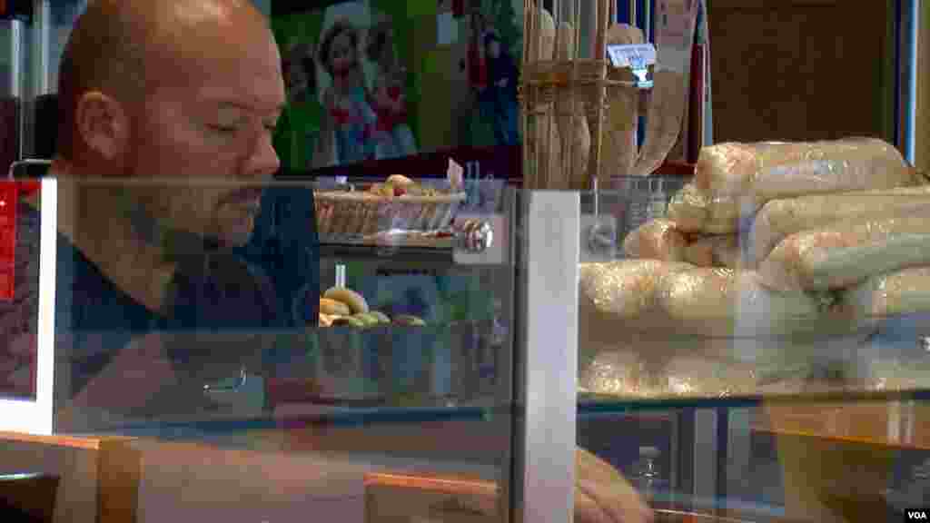 Bakery owner Frederic Van Gansbeke is seen at his shop in Calais, France. (L. Bryant/VOA)