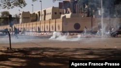 Security forces fire tear gas at people who gathered at Nation square to support military in Ouagadougou on Jan. 23, 2022. 