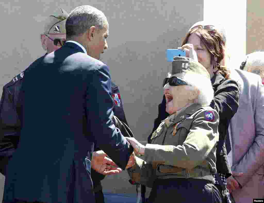 A World War II veteran reacts as she meets U.S. President Barack Obama during the 70th French-American Commemoration D-Day Ceremony at the Normandy American Cemetery and Memorial in Colleville-sur-Mer, France.