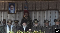 Iran's Supreme Leader Ayatollah Ali Khamenei, who has vowed to respond to strikes against its nuclear facilities with "iron fists," with Iranian military brass at an army academy graduation, Tehran, Nov. 10, 2011.