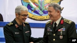 Turkey's Chief of Staff Gen. Hulusi Akar (R) and Iran's Chief of Staff of Armed Forces, Gen. Mohammad Hossein Bagheri, shake hands after a meeting in Tehran, Iran, Oct. 2, 2017.