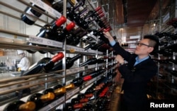 A manager looks at wines at the Marco Polo restaurant at the Grand Intercontinental Hotel in the Gangnam area of Seoul, South Korea, Oct. 2, 2012.