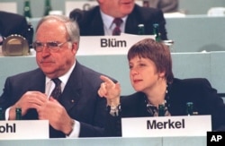 FILE - Angela Merkel next to then Chancellor Helmut Kohl. (AP Photo)