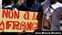 Des manifestants tiennent une pancarte sur laquelle on peut lire "Non à la France" lors d'une manifestation à Ouagadougou, au Burkina Faso, le 16 novembre 2021.