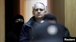 FILE - Former U.S. marine Paul Whelan, who is being held on suspicion of spying, is escorted out of a courtroom, in Moscow, Russia, Feb. 22, 2019. 