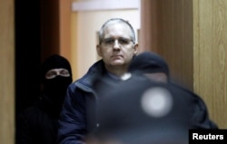 FILE - Former U.S. marine Paul Whelan, who is being held on suspicion of spying, is escorted out of a courtroom, in Moscow, Russia, Feb. 22, 2019.