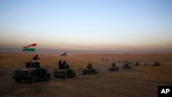 A peshmerga convoy drives toward a frontline in Khazer, about 30 kilometers east of Mosul, Iraq, Oct. 17, 2016. The Iraqi military and the country's Kurdish forces launched operations to the south and east of militant-held Mosul early Monday morning. 