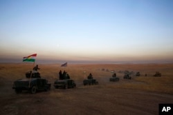 A peshmerga convoy drives toward a frontline in Khazer, about 30 kilometers east of Mosul, Iraq, Oct. 17, 2016. The Iraqi military and the country's Kurdish forces launched operations to the south and east of militant-held Mosul early Monday morning.