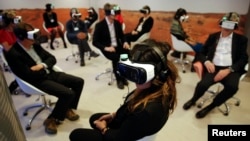 Participants attend the 'Collisions. A Virtual Reality World Premiere' event at the annual meeting of the World Economic Forum (WEF) in Davos, Switzerland January 21, 2016.