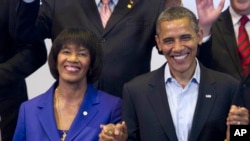 FILE - President Barack Obama and Jamaican Prime Minister Portia Simpson Miller pose for a photo at a multilateral meeting with Caribbean leaders during the sixth Summit of the Americas in Cartagena, Colombia, April 15, 2012.