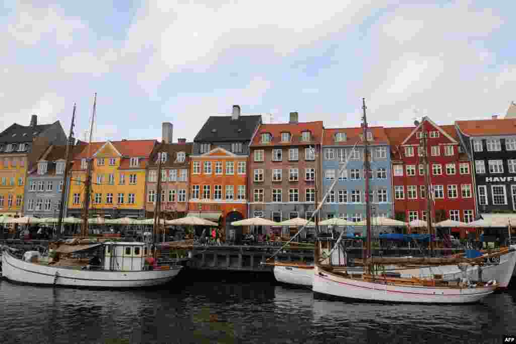 تصویری از ساختمان های قدیمی رنگارنگ و قابق های یک کانال در مرکز شهرکپنهاگ دانمارک