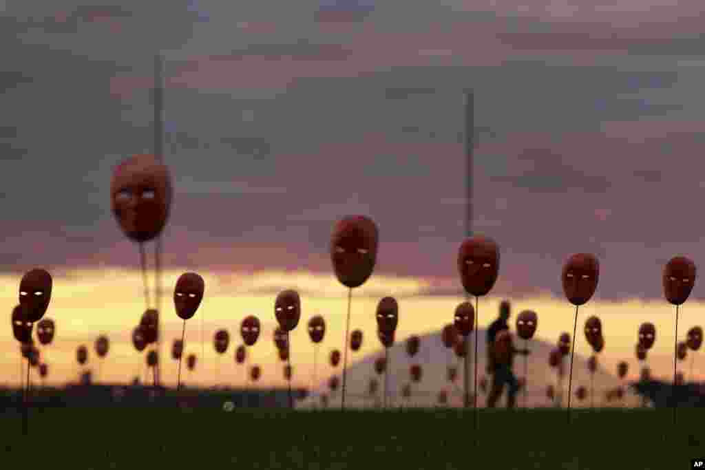 Masks representing corrupt politicians line the lawn outside the National Congress building in Brasilia. Brazil&#39;s Supreme Court has opened investigations into President Michel Temer for allegedly obstructing justice, passive corruption and being a member of a criminal organization. The move follows release of an audiotape that appears to show him endorsing the payment of hush money to an imprisoned former ally in exchange for silence.