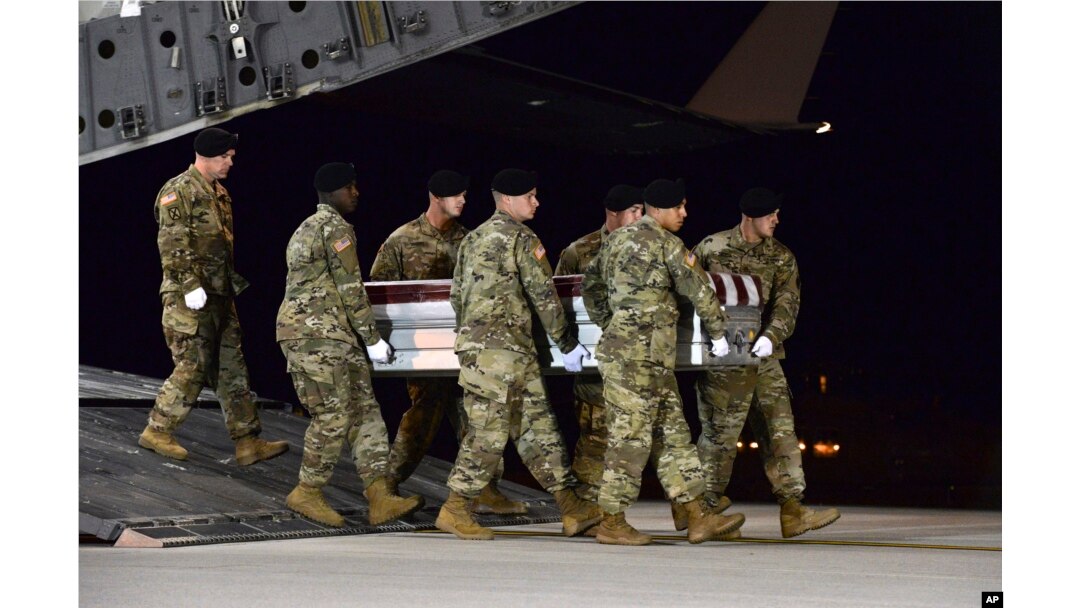 In this image provided by the U.S. Air Force, a U.S. Army carry team transfers the remains of Army Staff Sgt. Dustin Wright of Lyons, Ga., late Thursday, Oct. 5, 2017