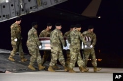FILE - In this image provided by the U.S. Air Force, a U.S. Army carry team transfers the remains of Army Staff Sgt. Dustin Wright of Lyons, Georgia, Oct. 5, 2017, at Dover Air Force Base, Delaware. Wright, 29, was one of four U.S. troops and four Nigerien soldiers killed in an ambush a day earlier.