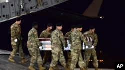 In this image provided by the U.S. Air Force, a U.S. Army carry team transfers the remains of Army Staff Sgt. Dustin Wright of Lyons, Ga., Oct. 5, 2017, upon arrival at Dover Air Force Base, Del. Wright, 29, of Lyons, Ga., was one of four U.S. troops and four Nigerien forces killed in an ambush by dozens of Islamic extremists on a joint American-Nigerien patrol. 