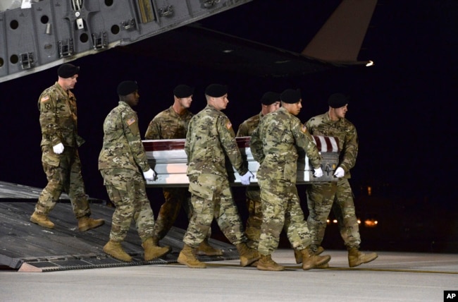 In this image provided by the U.S. Air Force, a U.S. Army carry team transfers the remains of Army Staff Sgt. Dustin Wright of Lyons, Georgia, Oct. 5, 2017, upon arrival at Dover Air Force Base, Delware.