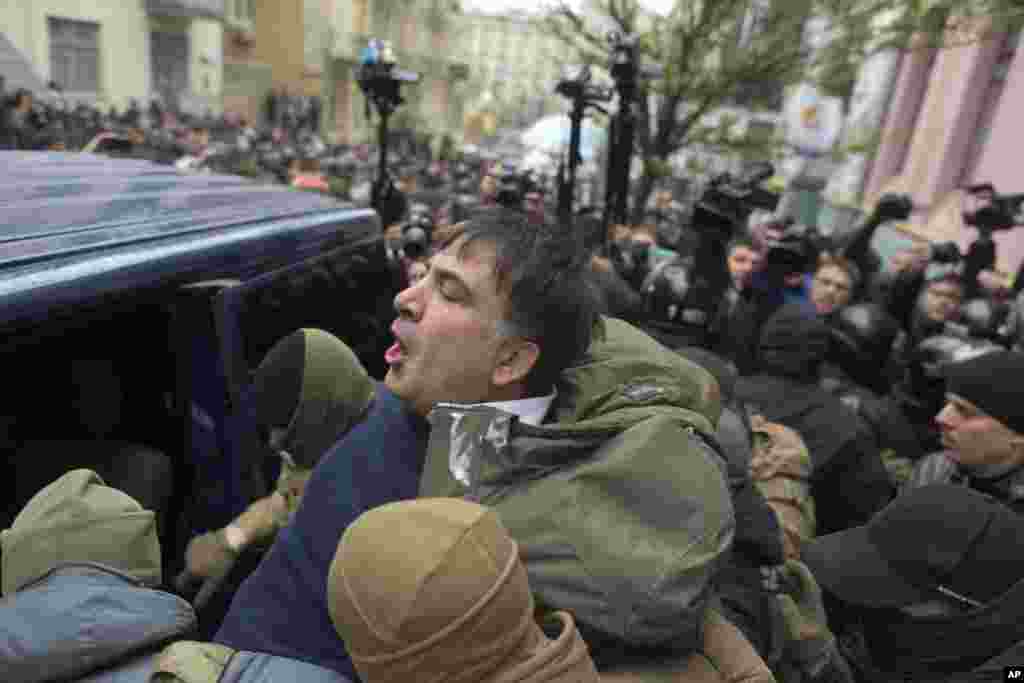 Ukrainian Security Service officers detain former president of Georgia Mikheil Saakashvili at his house in Kyiv, Ukraine, Dec. 5, 2017. Saakashvili has emerged as an anti-corruption campaigner in his new country but faced an angry backlash of protesters who would not let the officers take him away.