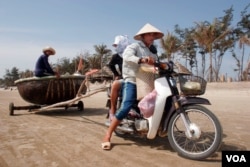 FILE - A motorbike is used to transport people and pull a fishing boat in Vung Tau. (Hai Do)