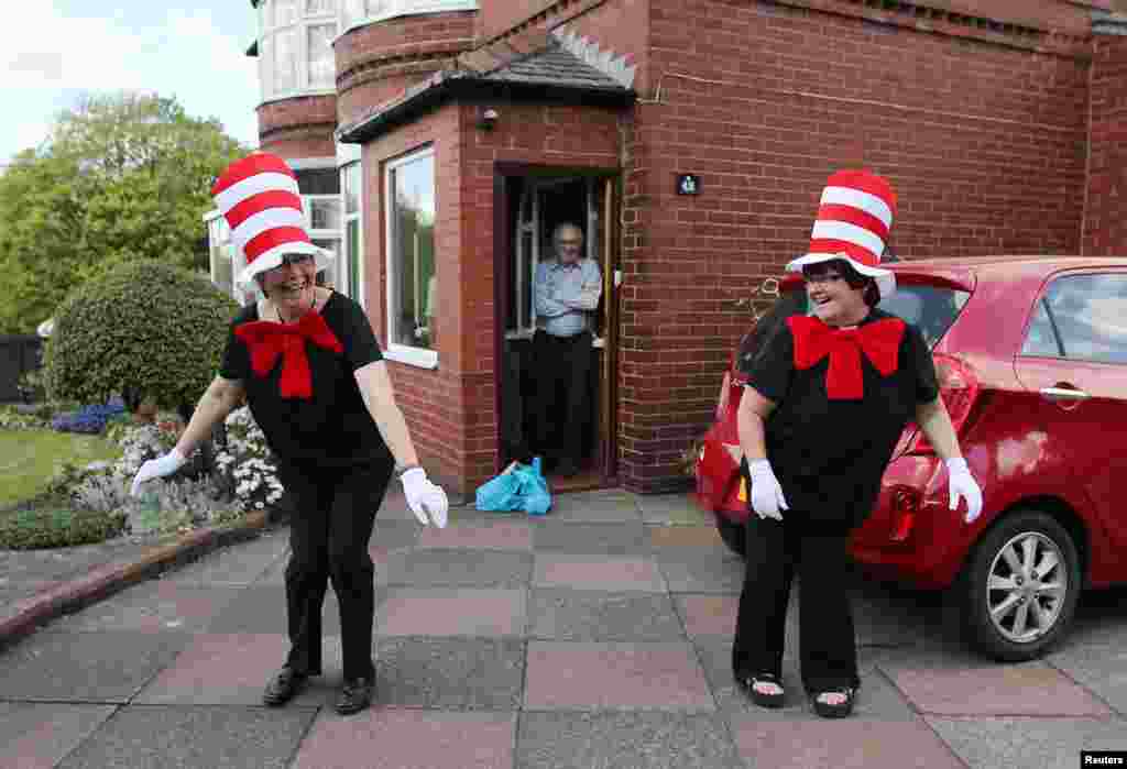 Viv and Carol from St. James&#39; church, dressed as the character Cat in the Hat, stand for a picture as they deliver meals to locals in need following the outbreak of the coronavirus disease (COVID-19), Bolton, Britain.