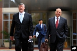 Kevin Downing, left, and Thomas Zehnle, attorneys for Paul Manafort, walk to the Alexandria Federal Courthouse in Alexandria, Va., Aug. 3, 2018, on day four of the former Donald Trump campaign chairman's tax evasion and bank fraud trial.