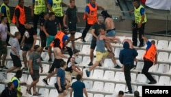 Soccer fans clash in Stade Velodrome, in Marseille, after a match, June 11, 2016. 