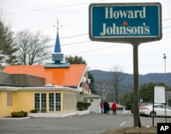 FILE - In this April 8, 2015, file photo, customers walk into Howard Johnson's Restaurant in Lake George, N.Y. The site of the last Howard Johnson's restaurant in the United States. (AP Photo/Mike Groll, File)