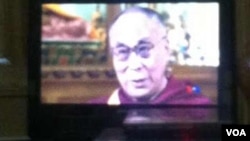 FILE - VOA interview with Dalai Lama as seen on TV screen in Tibet and posted on Wechat, the Chinese social media site.