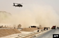 FILE - A U.S. black hawk helicopter flies over the site of a Taliban suicide attack in Kandahar, Afghanistan, Aug. 2, 2017.